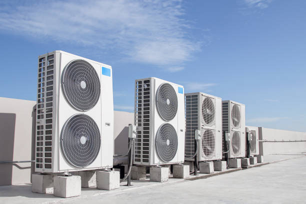 Rooftop air conditioning units against a clear blue sky