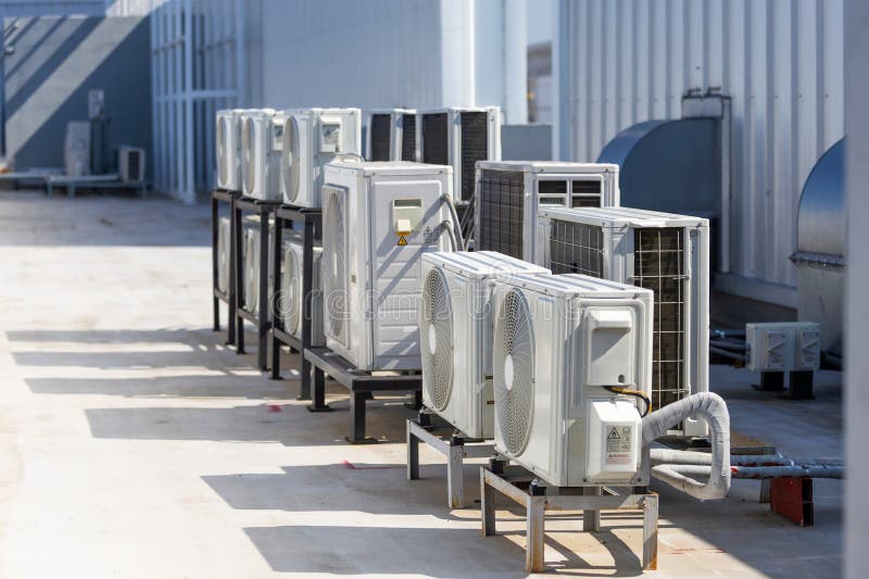 Multiple rooftop air conditioning units mounted on steel brackets
